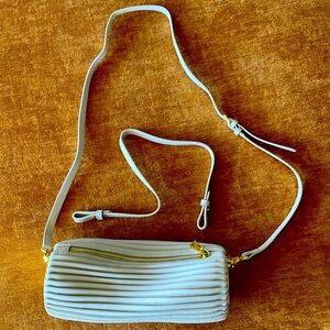 White Italian leather tube shaped purse.